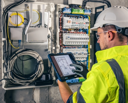 Man,,An,Electrical,Technician,Working,In,A,Switchboard,With,Fuses,