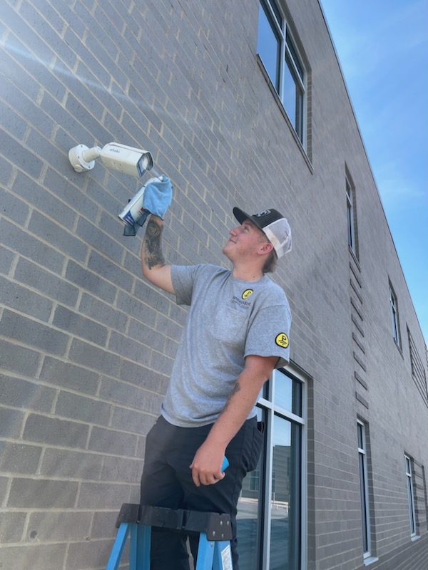 Technician Cleaning Camera Progressive Technologies
